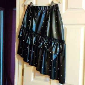 Leather look skirt with pearl accents.